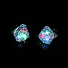 two rings with colorful lights on them in the black background, one is glowing and the other is shiny