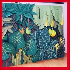 an artisticly designed paper art piece with tropical leaves and flowers on it's side