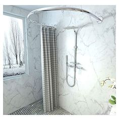 a bathroom with marbled walls and flooring, shower head is shown in the corner