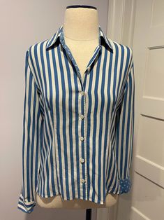 Barrie Pace blue and white striped shirt with polka dot lining Measurements: Bust: 36 in Shoulders: 16 in Sleeves: 22 in Length: 22 in Blue Long Sleeve Shirt With Contrast Stripes, Blue Collared Shirt With Vertical Stripes, Blue Vertical Stripes Top For Formal Occasions, Blue Vertical Striped Tops For Formal Occasion, Blue Vertical Stripes Formal Tops, Blue Long Sleeve Blouse With Vertical Stripes, Blue Collared Blouse With Striped Collar, Blue Vertical Striped Shirt For Work, Blue Vertical Stripe Shirt For Work