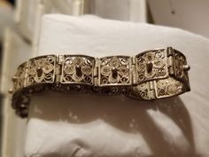 This is an elegant, delicate filigree vintage bracelet.  It has a floral design and a geometric design;  It is made up of tiny square sections joined together.  Each square has the same delicate filigree work.  The bracelet is solid and not hollow.       I am estimating the bracelet dates from 1920s to 1940s.  In the etsy date choice, they make you select a time.  I'm not sure on this item.  Please look at pics as they show detail.  You may know about time than me.   It is well made and signed . Victorian Bracelet, Cameo Earrings, Sterling Bracelets, Vintage Bracelet, It Is Well, About Time, Have A Blessed Day, Vintage Bracelets, Vintage Love