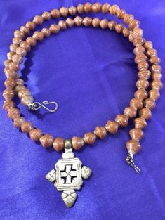 Ancient Olive wood beaded necklace with Coptic Ethiopia, 18th-19th century AD silver cross pendant.  Intricate detail. 29 inches long. Wood Bead Necklace, Silver Cross Pendant, Olive Wood, Silver Cross, Ethiopia, Wood Beads, Cross Pendant, Pendant Necklaces, 19th Century