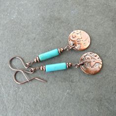 "Turquoise & copper dangle earrings - A 5/8\" copper disc embossed with a floral pattern is suspended from a dyed magnesite stone tube bead. Additional copper beads accent the stone top and bottom. I oxidized the copper to darken it, then tumbled and polished the earrings to brighten the highlights while leaving a dark patina in the recesses. These long slender earrings dangle about 2 1/4\" including their handcrafted copper ear wires. See my third image for an accurate illustration of scale Copper And Blue, Turquoise Dangle Earrings, Lanyard Necklace, Dangle Earrings Boho, Turquoise Earrings Dangle, Oxidized Copper, Earrings Turquoise, Sunglass Holder, Bird Earrings