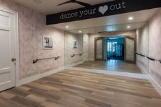 the entrance to a dance studio with wooden floors