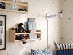 two shelves with stuffed animals on them in a child's bedroom