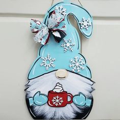 a door hanger decorated with an image of a gnome's hat and mug