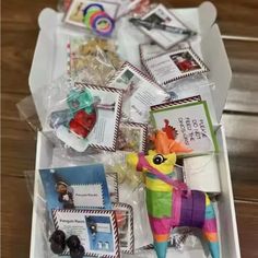 an open box filled with assorted items on top of a wooden table