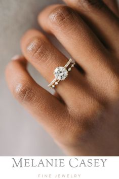 a woman's hand with a diamond ring on her finger and the words melanie casey fine jewelry