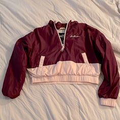 You Absolutely Will Love This Stunning New Without Tags Hollister Pullover. It Is Maroon & Pink With Jersey Gray Interior. It Is Adorned With A Zip Closure Mock Neck, Kangaroo Pocket With Snap Closure , Elastic Waist, Perfect For Exercise Or Just Lounging Around. It’s Light Weight & Looks Fabulous With A Cute Hat & Scarf. Perfect For All Seasons. Size Small. Measurements: Waist: 17” Across Shoulder To Shoulder: 23” Shoulder To Waist: 18 1/2” Arm Length: 18 1/2” Armpit To Wrist Pink Half-zip Top For Fall, Casual Pink Half-zip Outerwear, Trendy Pink Windbreaker With Pockets, Pink Long Sleeve Windbreaker With Pockets, Sporty Pink Tops With Pockets, Sporty Pink Top With Pockets, Pink Long Sleeve Windbreaker For Fall, Hollister Jackets, Cute Hat