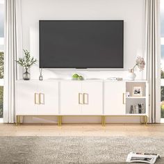 a large flat screen tv mounted to the side of a white entertainment center in a living room