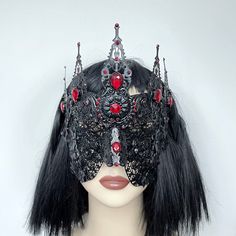 Viktoria Blindmask Beautiful ornate blindmask to unleash your evil queen fantasy. This mask has a spiked crown effect, finished with filigree flowers and red rhinestones on a plain black base. Perfect for gothic brides, engagement photoshoots, evil queen cosplays, alt events, music videos and more. Other colour variations available, please DM in advance with your request.  Handmade to order. This design will take between 3-6 weeks during busy times. ---------------------------------------------- Evil Queen Crown, Spiked Crown, Fantasy Couture, Couture Halloween, Gothic Bride, Oc Outfits, Mask Ideas, Halo Crown, Gothic Accessories