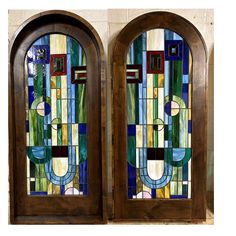 two stained glass doors with decorative designs on them, one is brown and the other is green