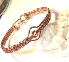 "Copper wire woven bracelet with a center love knot... it has 2 outer bands that are thicker 16 gauge and the inner bands are thinner 18 gauge.   The clasp is hook and loop.  Fits comfortably at 7.5\" or mention a custom length needed.   Comes in Silver too." Adjustable Copper Wire Bangle Bracelet, Adjustable Copper Wire Bangle, Adjustable Hand Wrapped Copper Wire Bracelets, Adjustable Wire Wrapped Braided Bracelet As Gift, Adjustable Wire-wrapped Copper Wire Bracelets, Adjustable Wire Wrapped Copper Wire Bracelets, Adjustable Copper Wire Wrapped Bracelets, Adjustable Rose Gold Wire Wrapped Bracelets, Wire Bracelets Diy