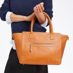 Indulge in the structured beauty of this exquisite bag, designed to elevate your everyday, commute or travel style. The tote is crafted from an exceptional leather produced without the use of any toxic chemicals, resulting in a natural material that is so clean it could be used in organic compost after its useful life has ended. The removable strap lets you wear it on your shoulder or carry in your hand with the robust top handles. Add a monogram for an elegant custom touch.  19"w (top) 12.5"w ( Classic Top Handle Box Bag For On-the-go, Versatile Tote Bag With Smooth Grain, Versatile Smooth Grain Tote Bag, Versatile Cognac Bag With Smooth Grain, Classic Top Handle Box Bag, Timeless Top Handle Satchel For Everyday, Timeless Everyday Top Handle Satchel, Classic Box Bag With Double Handle For On-the-go, Classic Everyday Box Bag With Double Handle