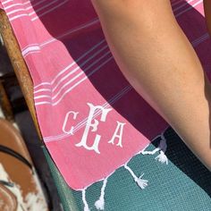 a towel with the initials on it is being held up by someone's hand