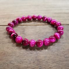 Pink Tiger Eye Stretch Bracelet  Handmade by me with 8mm hot pink tigers eye beads. Length is approximately 17cm (about 6.7in). Size can be adjusted and other bead sizes available upon supply. If one of the bead sizes you want is out of stock, send me a message and I will get them ordered asap! Genuine stones naturally vary, these are made to order so yours may look slightly different.  **Jewelry bundles get a FREE random gift, chosen by me; free shipping (when spending $35+) plus a gift gives you an added value of at least $12 or more :) ** Beaded Leaf, Turquoise Crystal, Tiger Eye Bracelet, Tiger Eye Beads, Custom Earrings, Leaf Charms, Tiger Eye, Charm Earrings, Stretch Bracelets