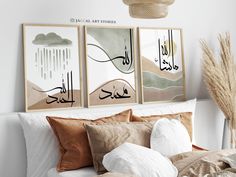 three framed pictures hang above a bed with pillows and blankets on it's headboard