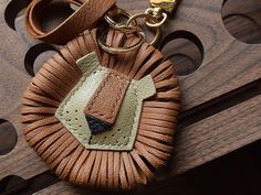 a leather keychain with a small piece of luggage on it's side