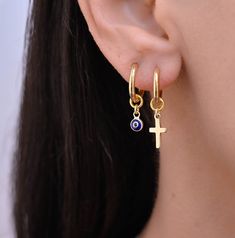 These small hoop earrings are a set of 2 mismatched huggie hoop earrings. The one earring has a evil eye charm on it while the other has a gold charm.  Hoops - Gold plated surgical stainless steel Charms - gold plated sterling silver 925 Small Hoop Huggie Earrings With Charms, Hoop Huggie Earrings With Dangling Charms For Gifts, Minimalist Hoop Earrings With Dangling Charms For Gift, Hoop Earrings With Charm, Huggie Earring, Hoops Gold, Conch Piercing, Earrings Hoop, Evil Eye Charm