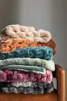 a stack of towels sitting on top of a wooden chair