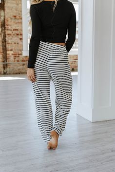 Introducing the Katelyn Striped Wide Leg Pants - the perfect blend of style and comfort! These pants feature a modern striped design and a wide leg cut that flatters your figure. Made with high-quality materials, these pants offer all-day comfort without compromising on style. Elevate your wardrobe with these versatile and chic pants. Model Info: Models are 5'7", Size 2, wearing smalls Material: 85% Polyester + 10%Cotton+ 5% Elastane Size Chart (INCH) Sizes Hip Inseam Trousers_Waist Outseam Bott Chic Striped Pants With Elastic Waistband, Striped Wide Leg Stretch Pants, Striped Stretch Wide Leg Pants, Striped Wide Leg Loungewear Bottoms, Striped Wide Leg Trousers With Elastic Waistband, Striped Trousers For Loungewear, Stretch Striped Pants For Loungewear, Relaxed Fit Loungewear Bottoms With Vertical Stripes, Striped Stretch Pants For Loungewear