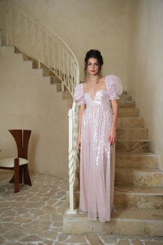 Allow us to introduce you to the Fairydust Maxi—a pink sequin masterpiece adorned with ethereal bubble sleeves that will transport you to a realm of pure, romantic whimsy. With a gown like this, every step is a glistening waltz, every shimmering glance a stolen moment, and every touch a promise of forever.  U- wire nec Wedding Moodboard, Empire Waistline, Top Skirt Set, The Wedding Date, Wedding Mood Board, Skirt Fits, Pink Sequin, Gathered Skirt, Ruffled Sleeves