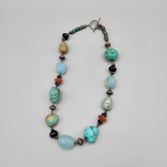 "Southwestern Boho mixed materials necklace with varied colors and sizes and textures. Smooth light blue glass beads, faceted orange colored beads, turquoise color dyed howlite, smooth round amethyst with alternating metal beads. Has a hang tag, but unknown maker to me. Excellent condition with no visible damage. Measurements: Length - 16\" A10D021522" Southwestern Turquoise Gemstone Beads Necklace, Artisan Jewelry With Oval Faceted Beads, Artisan Single Strand Turquoise Necklace For Jewelry Making, Artisan Turquoise Necklace For Jewelry Making, Bohemian Single Strand Round Jewelry, Adjustable Artisan Jewelry With Oval Beads, Southwestern Style Beaded Necklaces With Gemstone Beads, Artisan Adjustable Jewelry With Oval Beads, Artisan Turquoise Necklace With Faceted Beads