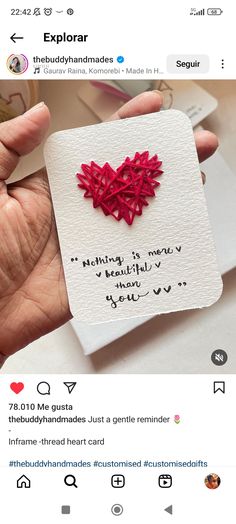 someone is holding up a card with a heart on it