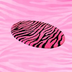 a pink and black zebra print oval shaped object floating in the air over a pink background