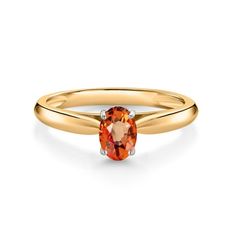 a gold ring with an orange stone in the center