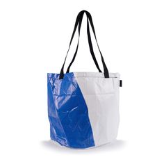 a large blue and white bag on a white background with black handles, two contrasting sides