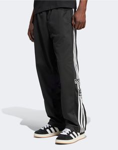 Pants & Chinos by adidas Originals Off-duty mood Regular rise Elasticated drawstring waist Side pockets adidas branding Press-stud side panels Relaxed fit Athleisure Jogging Bottoms With Three Stripes Branding, Athleisure Jogging Bottoms With Three Stripes, Athleisure Bottoms With Three Stripes For Jogging, Athleisure Jogging Bottoms With Side Stripes, Athleisure Bottoms With Side Stripes For Jogging, Sporty Joggers With Three Stripes And Relaxed Fit, Sporty Spring Joggers With Three Stripes Branding, Athleisure Sports Bottoms With Side Stripes, Spring Sporty Joggers With Three Stripes Branding