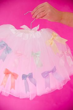 Your little one will be twirling and giggling in our MINI KIDS PASTEL BOWS TUTU! This white tutu features a comfortable elastic waist and adorable pastel bows for a touch of playful charm. Perfect for any occasion, it's sure to bring joy and cuteness to your child's wardrobe. Bow-utiful! This is a made-to-order item. All customized orders are currently shipping within 14 business days. To receive item quicker, expedited shipping is available at checkout. White Tutu Dress With Bow For Birthday, Playful White Tutu Dress With Ruffles, Spring Tulle Tutu Dress With Bow, Cute Spring Tutu Dress With Bow, Cute Tulle Tutu Dress For Playtime, White Bow Tutu Dress For Summer, White Whimsical Tutu Dress For Spring, Sweet White Tutu Dress For First Birthday, Whimsical White Tutu Dress For Spring