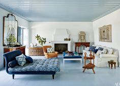 a living room filled with furniture and a fire place in the middle of the room