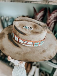 This burnt, distressed, felt fedora hat is a size 22 1/2 inches around.The hat band is an aztec and genuine leather band with a leather feather accent as well as a real feather and playing cards. This hat is burnt so it might have a slight smell for a few weeks.All feathers are glued to hold on the hat.FREE SHIPPING ON ALL OUR HAT ORDERS!All hats are branded by ©The Kiersten Zile CollectionNeed a Custom order? Message the Shop and we can start on that for you! Rustic Distressed Brown Fedora Hat Bands, Bohemian Felt Hat With Flat Crown For Ranch, Distressed Bohemian Hat Band For Festivals, Distressed Bohemian Hat Bands For Festivals, Bohemian Distressed Hat Bands For Festivals, Rustic Leather Hats For Festival, Rustic Flat Brim Felt Hat For Festivals, Artisan Leather Hat Bands For Rodeo, Artisan Leather Hat For Rodeo