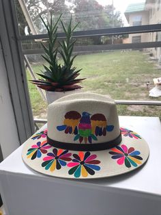 Mexican hand painted hat. The hat has a colorful floral design. Unique, colorful and fun to wear. The hat is made out of jute and it is light weight. Painted Sun, Colorful Hat, Safari Hat, Painted Hats, Floral Hat, Flower Hats, Dec 7, Floral Color, Summer Art