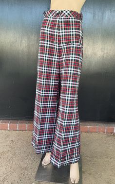 1970s Tomboy of California flare leg pants. White, red and blue cotton. Decorative buckles on sides on waist. Nylon zip front. One button fastener on waistband. Cuffed hems. Size 7 Measurements  26" waist 34" hips 43" length 32" inseam 30" hem sweep each leg Dashing pants show beautifully exhibiting no wear. Deadstock item having never been worn. Retro Red Bottoms For Fall, Retro High-waisted Cotton Wide Leg Pants, Retro High-waisted Wide Leg Cotton Pants, Retro Red Cotton Bottoms, Retro Wide-leg Cotton Pants, Red Retro Full-length Pants, Retro Full-length Red Pants, Red Full Length Retro Pants, Retro Red Full Length Pants