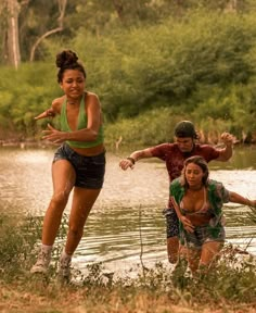 three young people are playing in the water