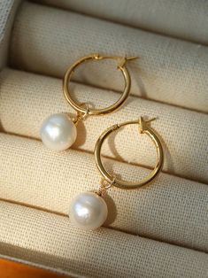 Experience elegant simplicity with our Baroque Pearl Drop Hoop Earrings. The near-round pearls add sophistication and versatility to any look. Celebrate the allure of natural beauty with their unique and exquisite form. Make a statement with these timeless, modern earrings. Metal: 18K Recycled Gold Plated On Brass Gemstone: Freshwater Pearl Pearl Dimensions: 11-11.5mm Dimensions: 3.5cm Weight: Single 3.5g Classic Gold Hoop Earrings With Pearl Charm, Elegant Hoop Pearl Earrings With Pearl Chain, Timeless Gold Round Pearl Earrings, Elegant Hoop Pearl Chain Earrings, Gold-plated Hoop Pearl Drop Earrings, Classic Gold Hoop Earrings With Pearl Chain, Gold Plated Round Pearl Charm Earrings, Small Hoop Pearl Earrings In Yellow Gold, Yellow Gold Pearl Small Hoop Earrings