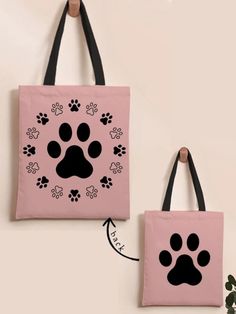 two pink bags with black paw prints hanging on the wall and one has a dog's paw print