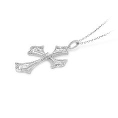 Faith meets fashion in this stylish diamond pave cutout cross pendant. Created in 18K white gold, this design features a polished diamond embellished scalloped-edged cross with a brilliant cut round sparkling diamond tying the design together.  A fashionable look she'll adore and wear daily as well as on special occasions. The perfect gift for an anniversary. 
0.65 carat pave setting
18k white gold
We offer a Free virtual Consultation from the comfort of your home so that you can Cross-shaped Diamond Necklace With Single Cut Diamonds, Luxury Cross-shaped Diamond Jewelry, Silver Diamond Cross Pendant Jewelry, Silver Brilliant Cut Cross Pendant Jewelry, Luxury Cross-shaped Diamond Cut Necklace, Luxury White Gold Cross Necklace, Luxury Silver Cross Necklace For Formal Occasions, Elegant White Cross Pendant Jewelry, Luxury Cross Necklace With Diamond Accents