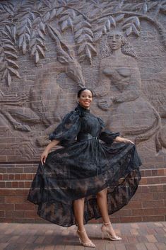 This gorgeous dress features lace detail a puff sleeve and a high low detail for an extra touch of glam! Belt not included. Model is wearing a small. Classy Dress Outfits Plus Size, Dress Outfits Plus Size, Black Women Dress, Hobble Skirt, Traditional African Clothing, Fancy Dress Design, Long Sleeve Floral Dress, Formal Style, Black Romper