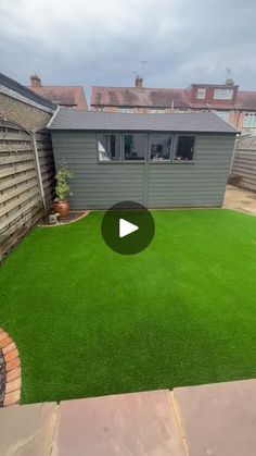 a backyard with artificial grass and landscaping