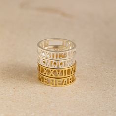 Cherish any meaningful date in your life with our intricate and unique Roman Numerals Ring. It's a great way of celebrating a deeply personal milestone through symbols that feel private to you. Material: High-Quality Solid 925 Sterling Silver Finish: Sterling Silver ∙ 18K Gold ∙ Rose Gold Dimension: 5mm height Personalized: This design can be customized with your Messages, Coordinates, Names, or Roman Numerals SKU: MM-RM03F30 Sizing Guide Rings are created true to standard US sizing. For the bes Symbolic Sterling Silver Stackable Rings For Anniversary, Symbolic Adjustable Stackable Rings For Anniversary, Symbolic Sterling Silver Rings For Anniversary, Symbolic Rose Gold Promise Rings, Classic Promise Stackable Rings, Gold Sterling Silver Midi Rings For Anniversary, Gold Symbolic Midi Rings For Anniversary, Minimalist Jewelry With Hallmarks For Anniversary, Stamped 925 Rings For Mother's Day Wedding