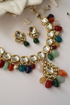 This navrattan necklace set with its pop of colors and quirky shapes is a sublime piece. The subtelty of the polki with hints of muted golden tones creates the perfect balance to create a winning look. Necklace Closure - Adjustable Dori Earrings Closure - Push Back Style Tip - This multicolored piece of art is perfect for gracing traditional funtions in full pomp and show. Navrattan itself being the traditional epitome of prosperity, wealth and status. What could be better than Handcrafted in Ja Multicolor Temple Jewelry Necklace As Gift, Festive Multicolor Kundan Necklace, Multicolor Temple Jewelry Necklace For Gift, Multicolor Temple Jewelry Necklaces For Gift, Traditional Colorful Jewelry For Festivals, Festive Multicolor Kundan Necklace As Gift, Multicolor Traditional Kundan Necklace For Party, Traditional Multicolor Kundan Necklace For Party, Multicolor Festive Necklace For Parties