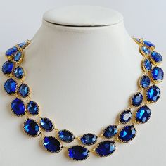 These Anna Wintour style statement necklaces are made with beautiful vintage buttons with oval crystals in two size, small 10x14 mm and large 13x18 in beautiful Sapphire color. The crystals are accentuated beautifully with the gold brass setting. You can wear them separately or layer them all together for full impact,  sure to get compliments and attention. Their versatility makes them perfect for parties and other celebratory gatherings. Quality of the stones and settings makes them a perfect candidate for becoming heirloom pieces. It is elegant, classy and very "Anna Wintour style". Crystals - 10x14 mm Oval point back strass. Crystal Colour Sapphire. Necklace setting - Gold Brass (nickel, cadmium and lead free). Necklace length - Measures 16 inches, it also has 1,5 inch extension chain f Oval Crystal Jewelry With Rhinestones, Oval Jeweled Crystal Jewelry, Oval Costume Jewelry For Parties, Oval Crystal Necklaces For Parties, Gold Oval Necklace For Party, Oval Gold Necklace For Party, Anna Wintour Style, Necklace Gold Jewelry, Statement Necklace Gold