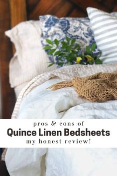 an unmade bed with white linens and blue flowers on the headboard, text reads pros & cons of quince linen bedsheets my honest review