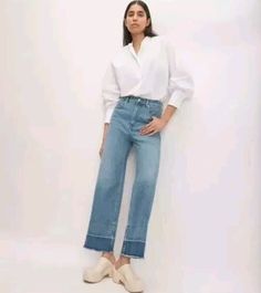 Everlane The Way High Sailor Jeans for women, Size 33 Short feature a cropped wide leg, high-rise design in a tint blue color, released shade raw hem Made from a cotton blend denim, they offer comfort and stretch. The jeans have a raw hem and a cropped length, with a 5-pocket design and a button and zip closure. Ideal for a festival or beach look, they are versatile casual pants Great new with tags Size 33 Short Waist 18" Rise 14" Hip 23" Inseam 27" Leg opening 12" Sailor Jeans, Sailor Jean, Everlane Jeans, Short Waist, Jeans For Women, Beach Look, Pocket Design, A Button, Casual Pants