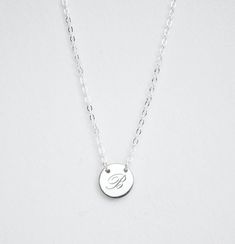 INITIAL NECKLACEThis beautiful minimalist initial or letter pendant necklace is perfect for everyday wear. It would make the perfect gift for a friend, mom, bridesmaid, or any loved one! The small round disk is held in place on the chainIf you want a layered look, click here to view the second necklace shown on our model - our 16mm size.DESCRIPTION• Material: High quality solid 925 sterling silver• Dimensions: 9mm disc• Finish: Sterling Silver ∙ 18K Gold ∙ Rose Gold• All our jewelry is custom an Silver Minimalist Personalized Initial Necklace, Minimalist White Gold Name Necklace, Minimalist Rose Gold Initials Necklace, Delicate Silver Initial Pendant Name Necklace, Delicate Silver Initials Name Necklace, Delicate Silver Initial Pendant Necklace, Minimalist Initial Pendant Charm Necklace For Wedding, Minimalist Initial Necklaces For Anniversary, Minimalist Silver Initial Necklace For Anniversary