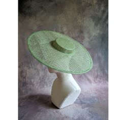 One cartwheel woven sinamay straw hat base in light green that measures approximately 17.25" (43.8cm) in diameter. Crown is 1.25" (3cm) high. The edges of the brim are finished in wired sinamay. The multi-layer stiffened sinamay straw has a great sturdy weave and provides excellent support for your millinery creations. This is NOT a ready to wear finished hat and will not stay on your head unless you add a head band or elastic to wear. Add embellishments of your choice. A nice high quality base - I know you'll be pleased! This hat base is listed separately in lots of different colors. Check my listings for those... Lots of hat bases and millinery supplies listed in my shop   www.etsy.com/shop/apinkswan  ! Thanks for looking - feel free to convo me with any questions you may have. Spring Sinamay Boater Hat With Short Brim, Spring Boater Hat With Short Brim In Sinamay, Adjustable Sinamay Straw Hat For Spring, Green Mini Hats For Church In Spring, Green Mini Hat For Kentucky Derby And Beach, Green Adjustable Straw Hat With Short Brim, Elegant Green Straw Hat With Short Brim, Adjustable Green Panama Hat With Short Brim, Green Panama Hat With Curved Brim And Adjustable Fit